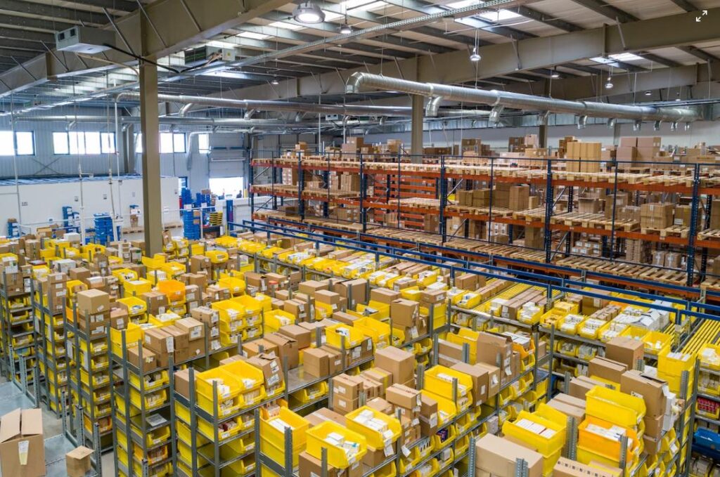 Warehouse full of isles of racks of items.